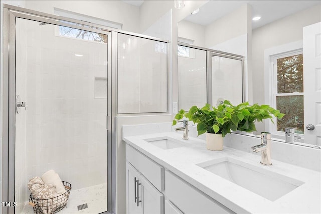 bathroom with vanity and a shower with shower door