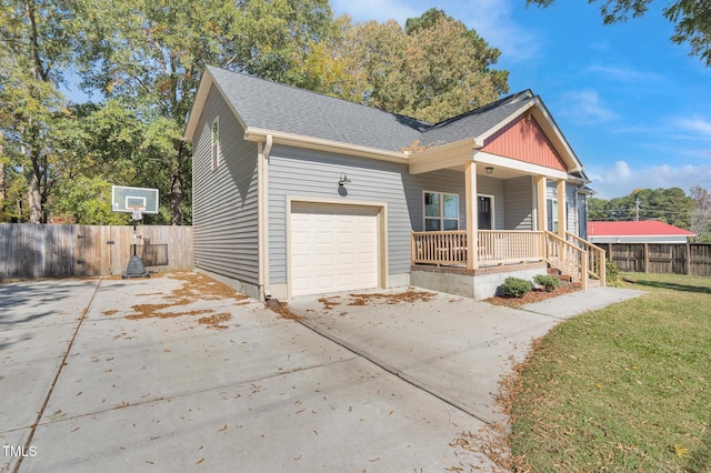 view of front of house featuring a front lawn, a porch, and a garage