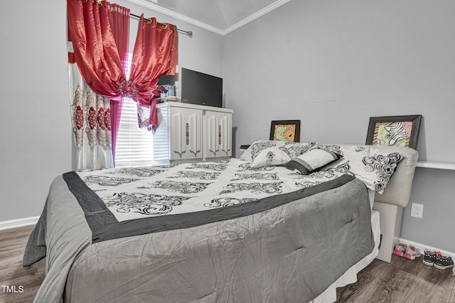 bedroom featuring hardwood / wood-style flooring and ornamental molding