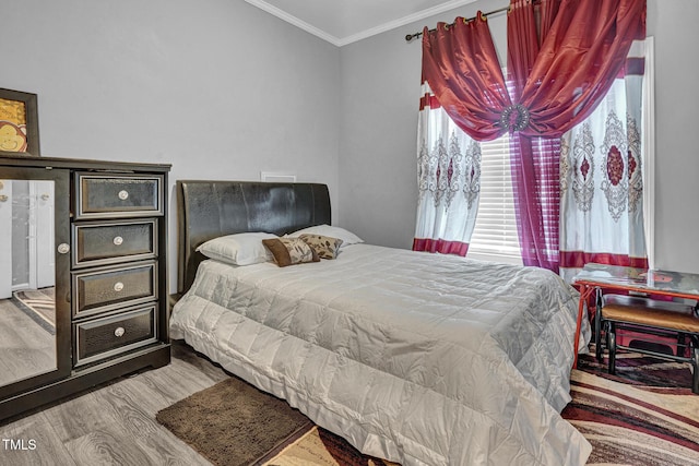 bedroom with wood-type flooring and crown molding