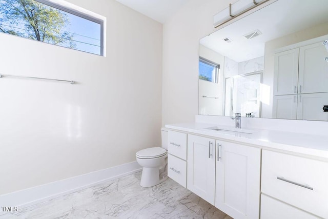 bathroom with plenty of natural light, toilet, a shower with door, and vanity