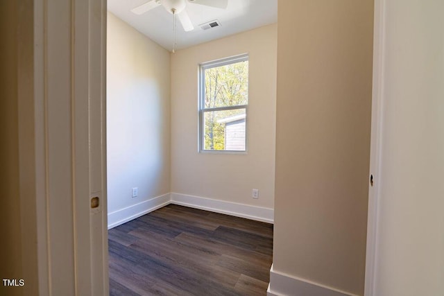 empty room with dark hardwood / wood-style floors and ceiling fan