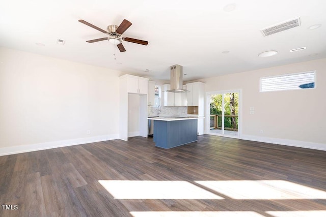 unfurnished living room with ceiling fan, dark hardwood / wood-style flooring, and sink