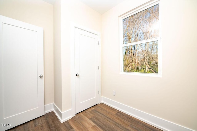 corridor with hardwood / wood-style flooring