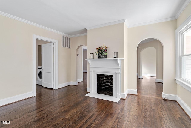 unfurnished living room with washer / dryer, crown molding, and dark hardwood / wood-style floors