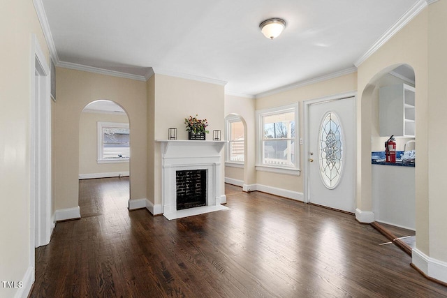 entryway with dark hardwood / wood-style flooring and crown molding