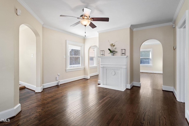 empty room with ornamental molding, ceiling fan, and dark hardwood / wood-style floors