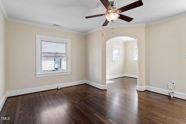 spare room featuring ceiling fan, dark wood-type flooring, and ornamental molding