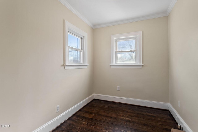 empty room featuring ornamental molding and dark wood-type flooring