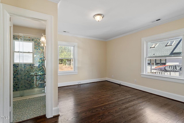 empty room featuring ornamental molding and dark hardwood / wood-style floors