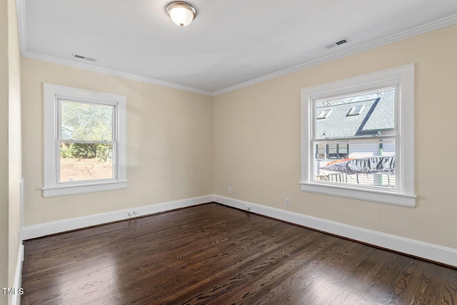 spare room with a healthy amount of sunlight, dark wood-type flooring, and crown molding