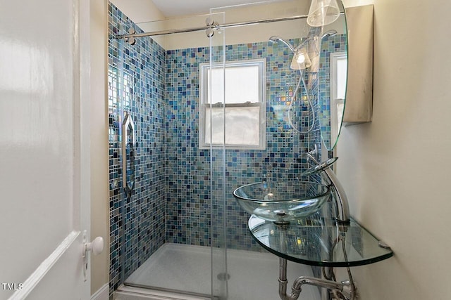 bathroom featuring a shower with shower door