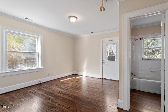 interior space featuring plenty of natural light, crown molding, and dark hardwood / wood-style floors