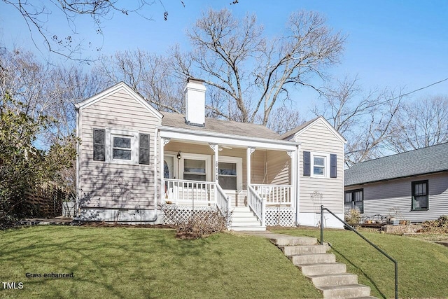 view of front of home with covered porch and a front lawn