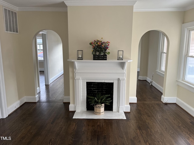 unfurnished living room featuring dark hardwood / wood-style flooring and crown molding