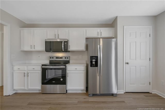 kitchen featuring light hardwood / wood-style floors, white cabinetry, and stainless steel appliances