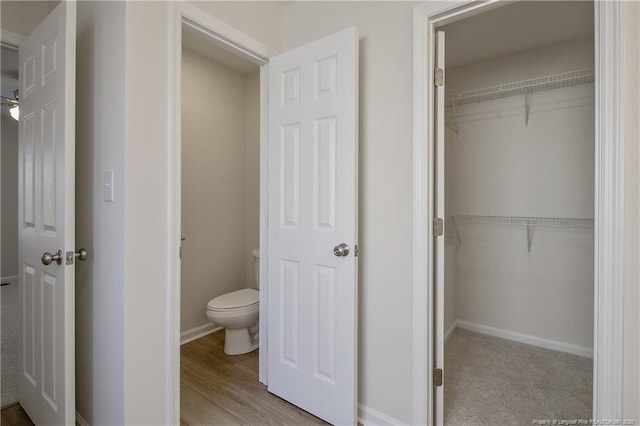 bathroom featuring hardwood / wood-style flooring and toilet