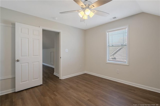 unfurnished room featuring ceiling fan, dark hardwood / wood-style flooring, and lofted ceiling