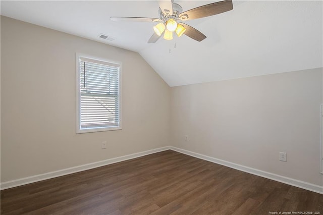 additional living space with ceiling fan, dark hardwood / wood-style flooring, and vaulted ceiling