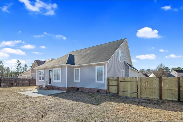 back of property featuring a yard and a patio area