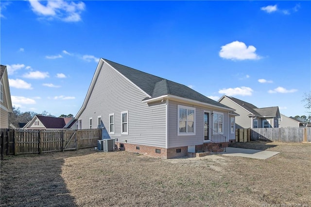 back of house featuring a lawn, central AC, and a patio