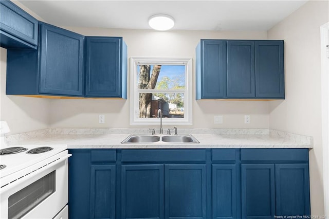 kitchen with white range with electric stovetop, sink, and blue cabinetry