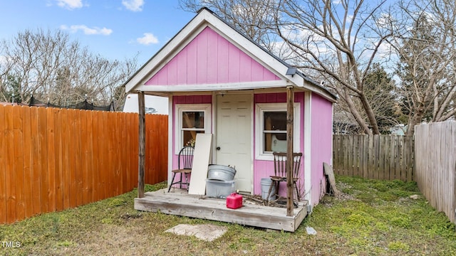 view of outbuilding featuring a fenced backyard and an outdoor structure