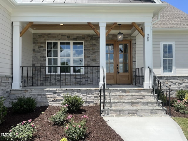 25 Deer Tail Ln Lot 52, Fuquay Varina, NC 27526 - entrance to property with stone siding, covered porch, french doors, and a shingled roof