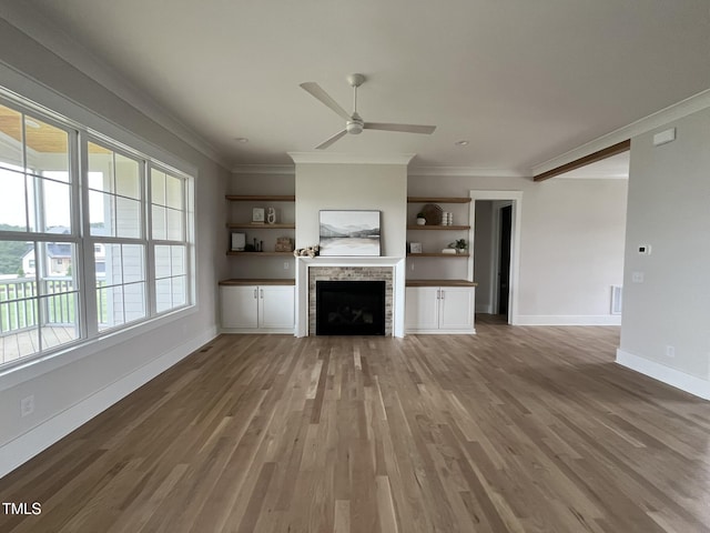 25 Deer Tail Ln Lot 52, Fuquay Varina, NC 27526 - unfurnished living room with crown molding, wood finished floors, ceiling fan, a fireplace, and baseboards