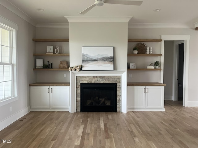 25 Deer Tail Ln Lot 52, Fuquay Varina, NC 27526 - unfurnished living room with ornamental molding, ceiling fan, light wood-style flooring, a brick fireplace, and baseboards
