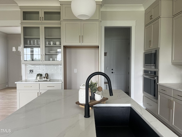 25 Deer Tail Ln Lot 52, Fuquay Varina, NC 27526 - kitchen with stainless steel appliances, decorative backsplash, light stone countertops, glass insert cabinets, and a sink