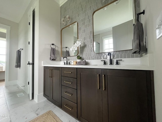 25 Deer Tail Ln Lot 52, Fuquay Varina, NC 27526 - full bath with marble look tile flooring, double vanity, baseboards, and decorative backsplash