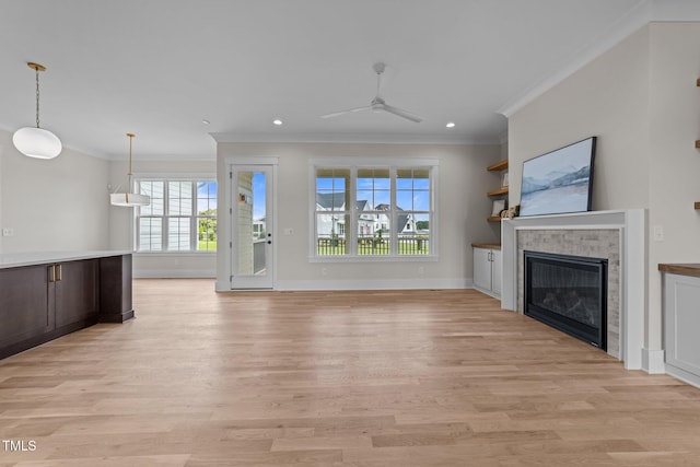 25 Deer Tail Ln Lot 52, Fuquay Varina, NC 27526 - unfurnished living room featuring ornamental molding, ceiling fan, light wood-type flooring, a glass covered fireplace, and recessed lighting