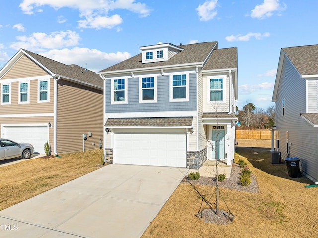 view of front of house with a front yard and a garage