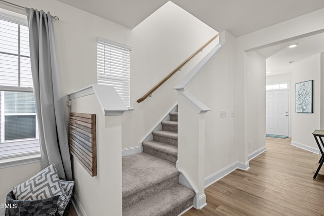 stairs with hardwood / wood-style floors