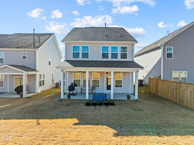 back of house with a lawn, cooling unit, and a patio area