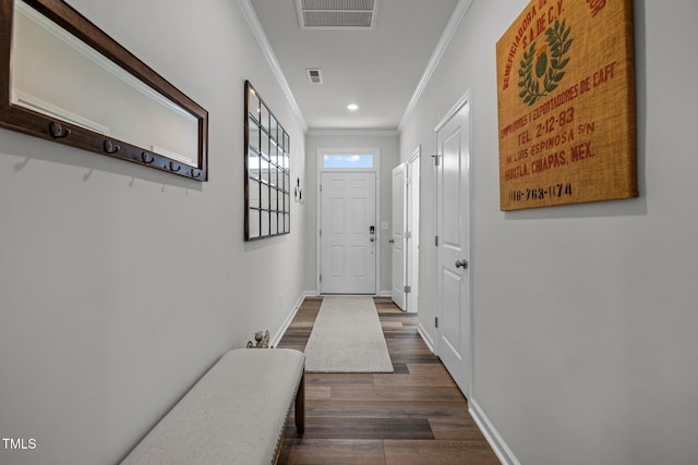 doorway with dark hardwood / wood-style flooring and ornamental molding