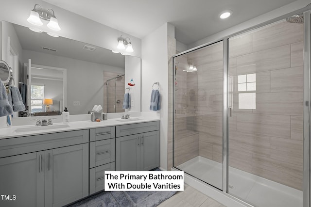 bathroom featuring tile patterned flooring, vanity, and an enclosed shower