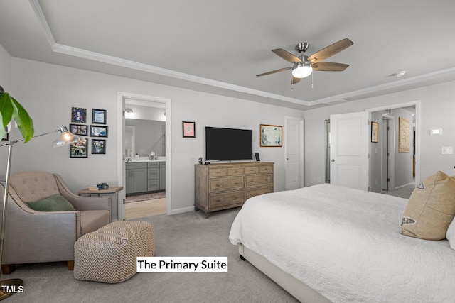 bedroom featuring ensuite bath, ceiling fan, crown molding, light colored carpet, and a tray ceiling