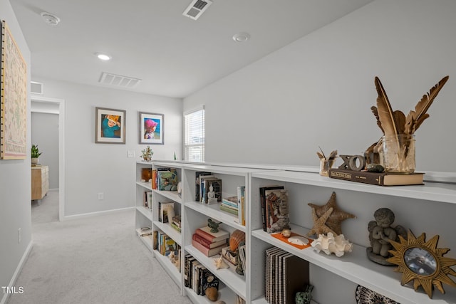 hall featuring light colored carpet