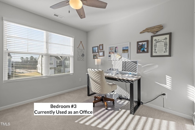 carpeted home office with ceiling fan