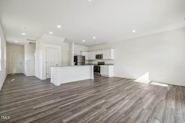 unfurnished living room featuring dark hardwood / wood-style flooring