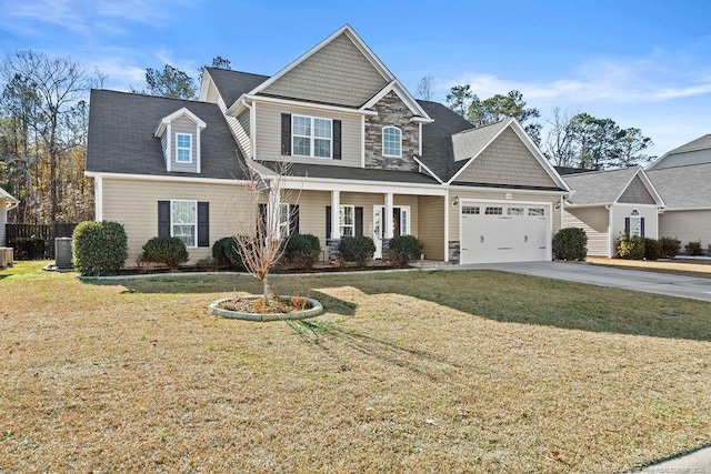 view of front of house with a garage, central air condition unit, and a front yard