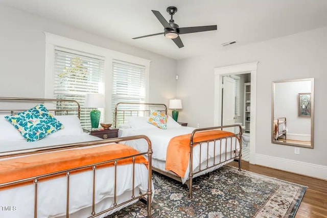 bedroom with ceiling fan and dark wood-type flooring