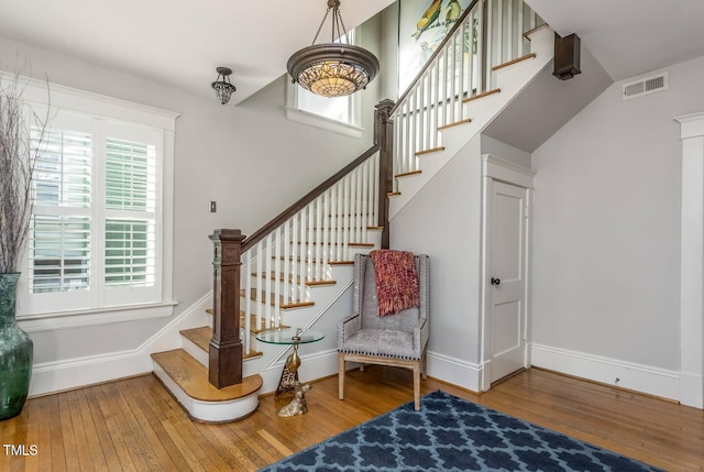 stairway with hardwood / wood-style flooring