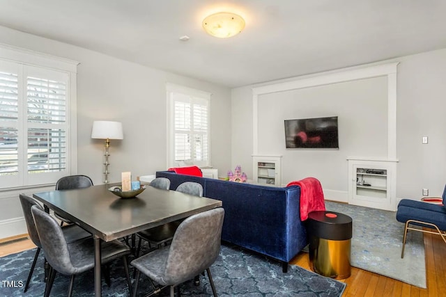 dining area with a wealth of natural light and hardwood / wood-style floors