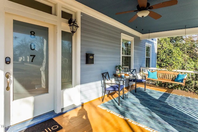 wooden deck with covered porch and ceiling fan