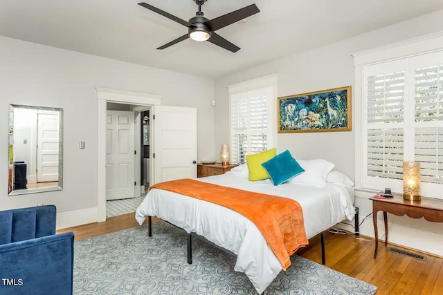 bedroom with ceiling fan and wood-type flooring