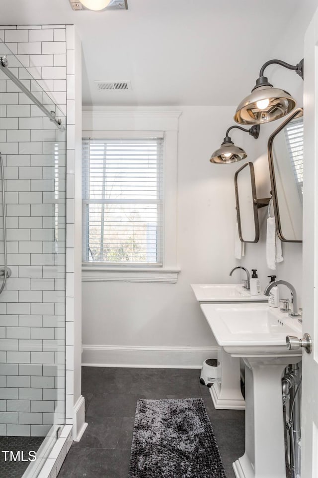 bathroom with sink and tiled shower