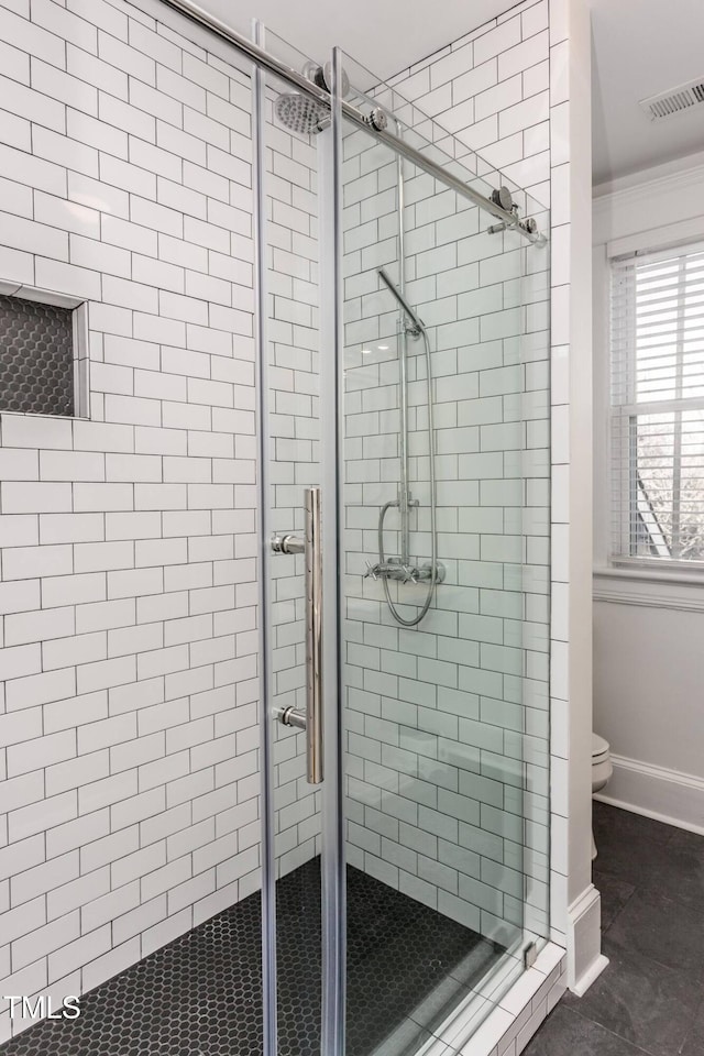 bathroom featuring walk in shower and toilet